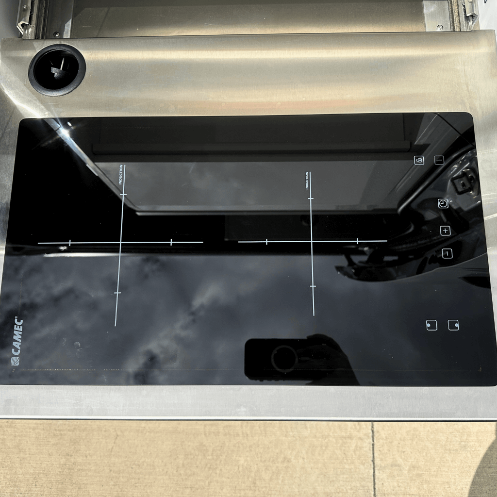 Camec Induction cook top on slide in campervan